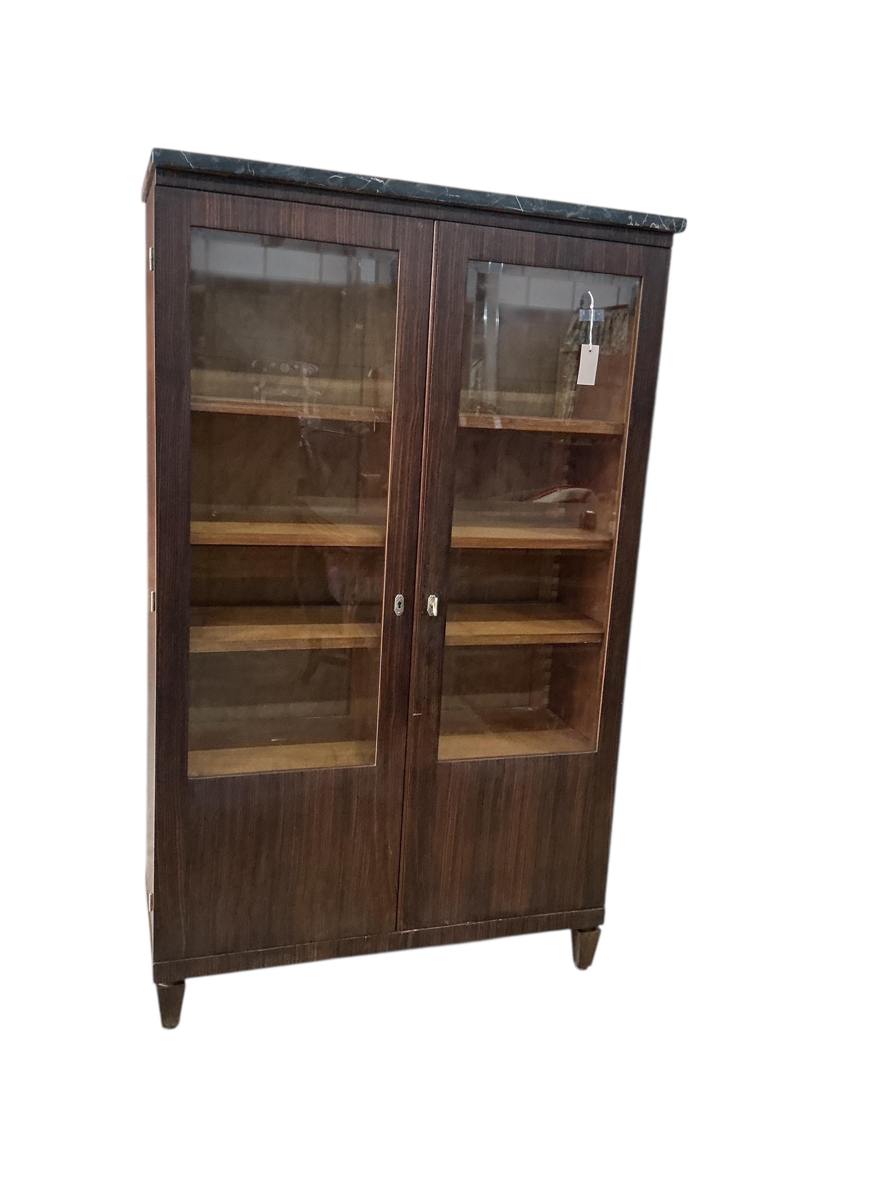 A French Art Deco marble topped coromandel bookcase, width 92cm, depth 38cm, height 151cm